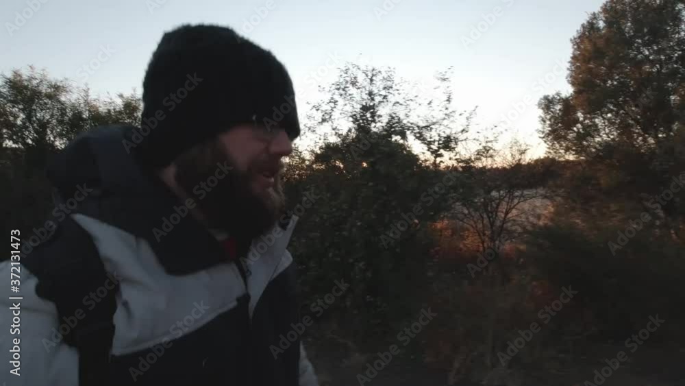 Man walking on a trail during winter time Man walking on a trail during winter time