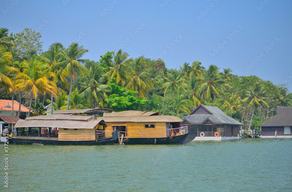 House boat sailing on Ashtamudi lake in kerala backwaters in kollam House boat sailing on Ashtamudi lake in kerala backwaters in kollam