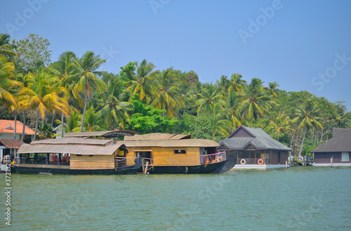 House boat sailing on Ashtamudi lake in kerala backwaters in kollam photo