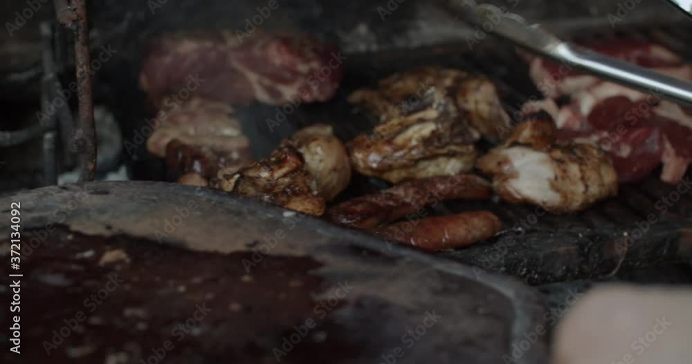 4K at 60fps (slow motion) / Man cooking a barbecue on a rusty grill on a sunny day / BBQ (asado) / Relax and warm mood 4K at 60fps (slow motion) / Man cooking a barbecue on a rusty grill on a sunny day / BBQ (asado) / Relax and warm mood