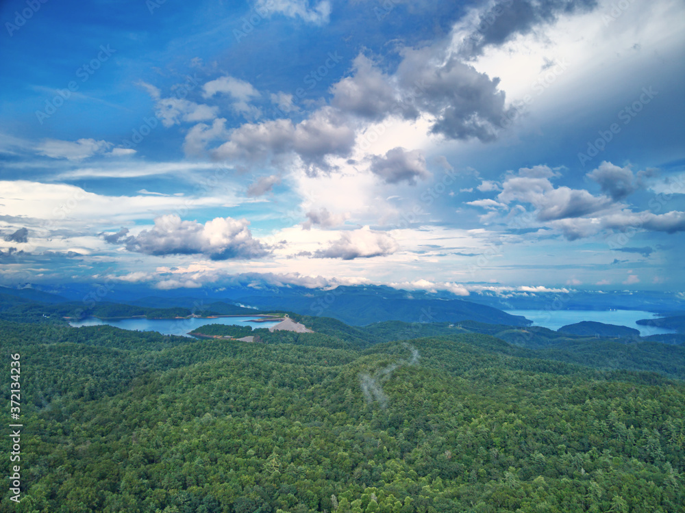 A mountain overlook viewing Lake Jocassee and Bad Creek reservoir with clouds in the background.