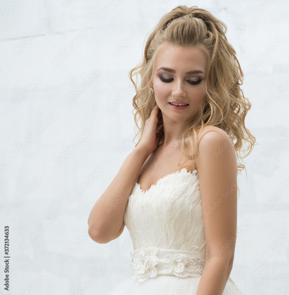 Gorgeous young bride with nice bouquet in studio Gorgeous young bride with nice bouquet in studio