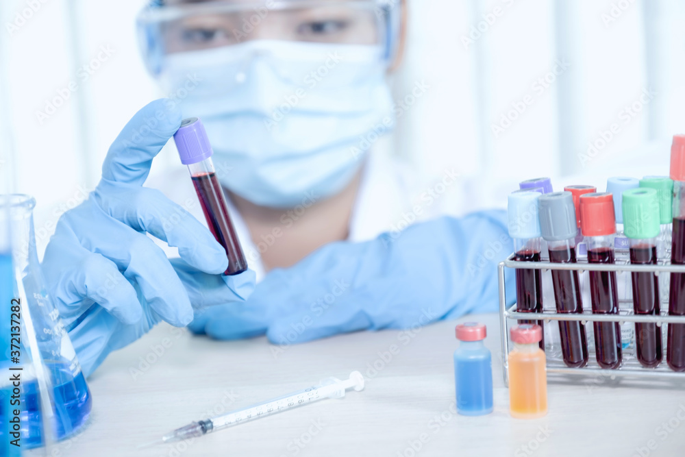 doctor's hand holding a sample blood tube for analysis and test virus disease in the laboratory, This research is plasma biomedicine for diagnostic medical healthcare doctor's hand holding a sample blood tube for analysis and test virus disease in the laboratory, This research is plasma biomedicine for diagnostic medical healthcare