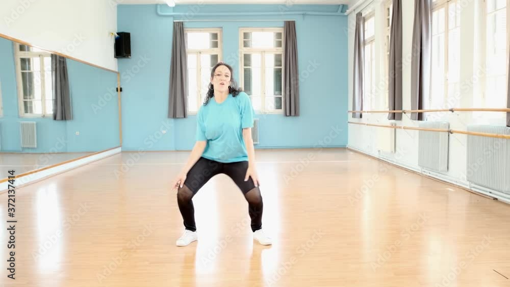 Loopable,beautiful young woman in dance studio practicing her moves. Loopable,beautiful young woman in dance studio practicing her moves.