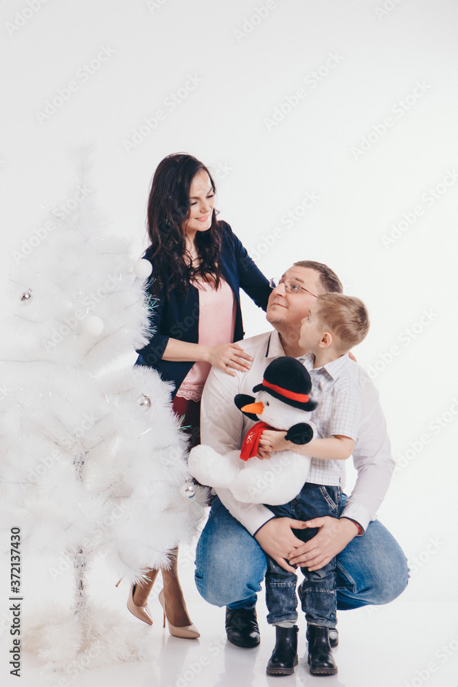 family at the Christmas tree. woman and child isolated on a white background. new year celebration. family at the Christmas tree. woman and child isolated on a white background. new year celebration.