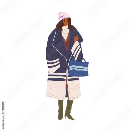 Black skin woman demonstrate stylish outerwear vector flat illustration. Trendy girl in warm down jacket or coat and hat isolated. Female in colorful street style winter, spring or autumn clothing