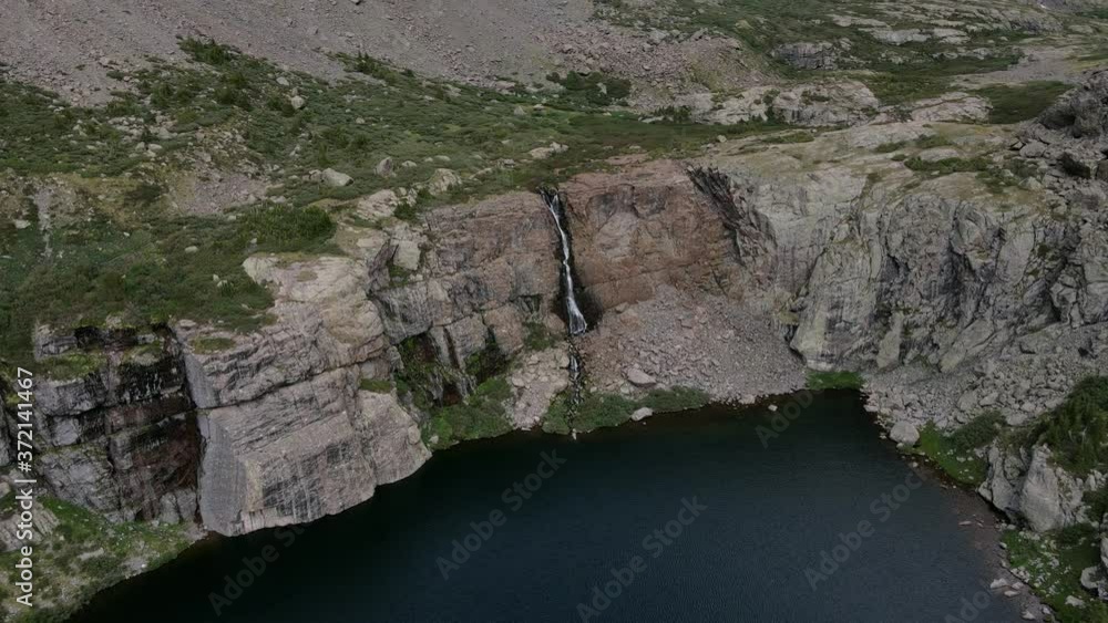 Aerial view moving forward shot, Scenic view waterfall on the side of a cliff in Sangre de Cristo Mountain Range in Rocky Mountains of America. Aerial view moving forward shot, Scenic view waterfall on the side of a cliff in Sangre de Cristo Mountain Range in Rocky Mountains of America.