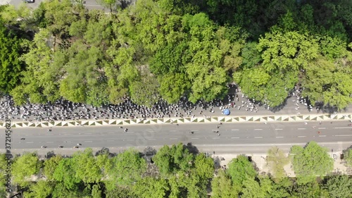 Vista aérea cenital sobre Paseo de la Reforma de una multitud marchando y manifestándose contra el gobierno de México photo