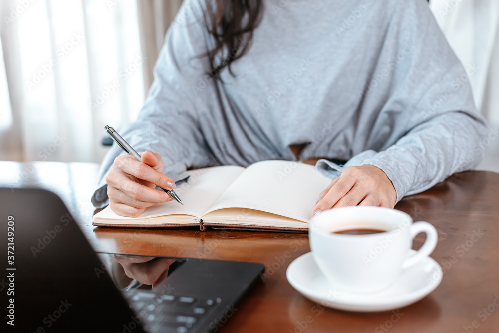 Student learning and hold pen for writing a note. Student learning at home. Student learning and hold pen for writing a note. Student learning at home.