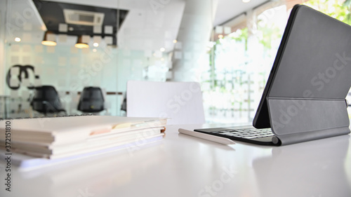 Cropped shot view of modern home office workspace with laptop on white table. © Kittipong