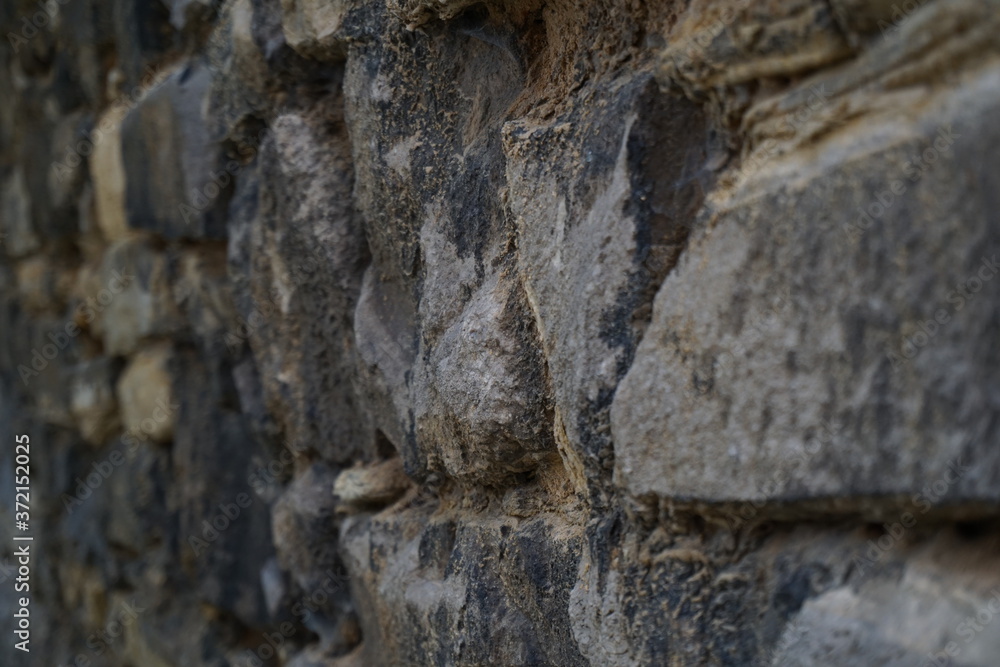 Fototapeta premium old decaying stone wall in the city
