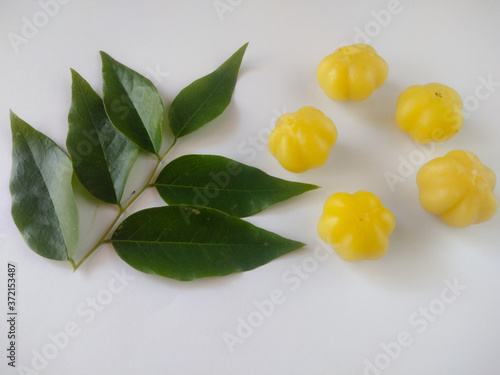 Fresh Phyllanthus acidus or cermai fruit and green leaves on white background.Phyllanthus acidus is a fruit that tastes sour and lots of vitamins