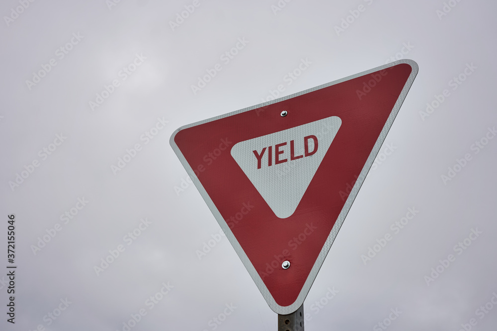 Yield Sign Against Overcast Sky Background. A Give Way Sign Which ...