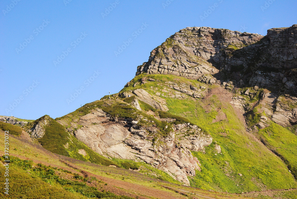 mountains with green grass and blue sky. georgeous nature