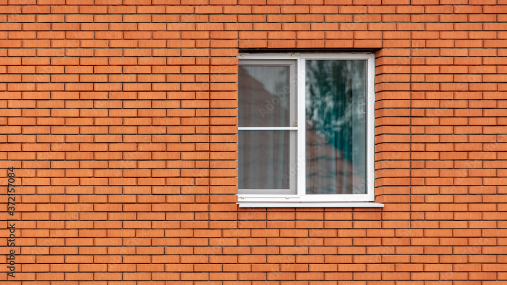 Window in a red brick wall as an abstract background Window in a red brick wall as an abstract background