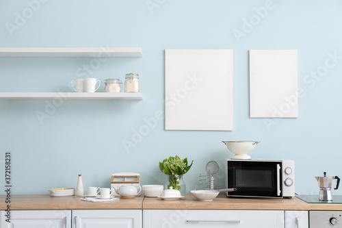 Set of utensils with microwave oven in kitchen © Pixel-Shot