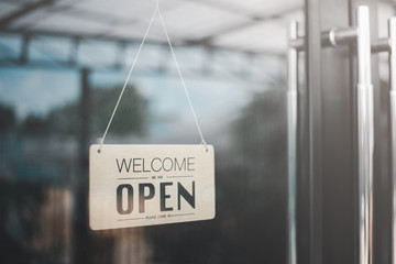 "Open" on cafe or restaurant hang on door at entrance.