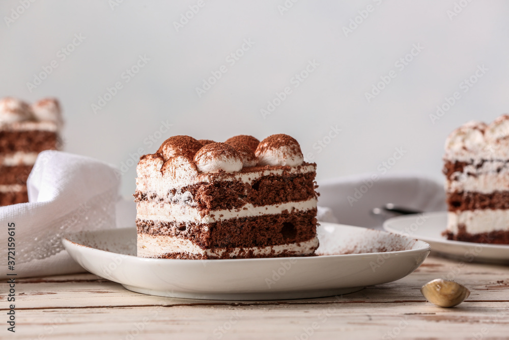 Plate with tasty tiramisu on table Plate with tasty tiramisu on table