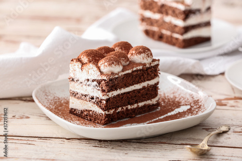 Plate with tasty tiramisu on table