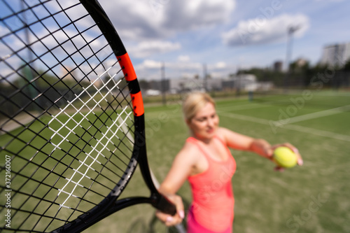 Woman playing tennis holding a racket and smiling © Angelov