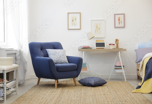 Modern teenager's room interior with comfortable armchair