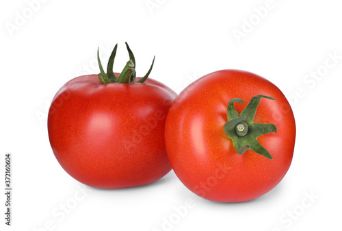 Tasty ripe tomatoes with leaves isolated on white