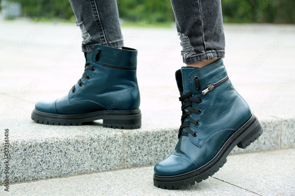 Woman wearing comfortable stylish boots outdoors, closeup