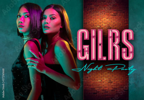 Portrait of two young cute Asian women in elegant dresses on the pink and yellow neon lights. Sexy disco women, girls night party banner concept