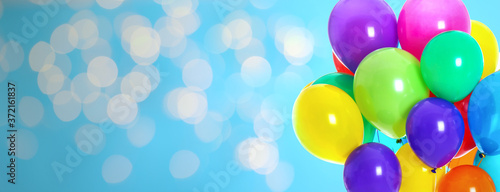 Photography Bright balloons on color background with bokeh effect, space for text