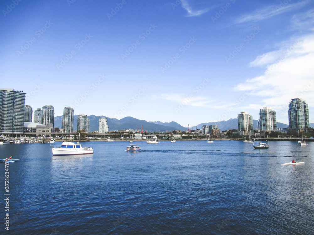 Beautiful scene with boats, houses, sea bay and mountains in Vancouver at summer.