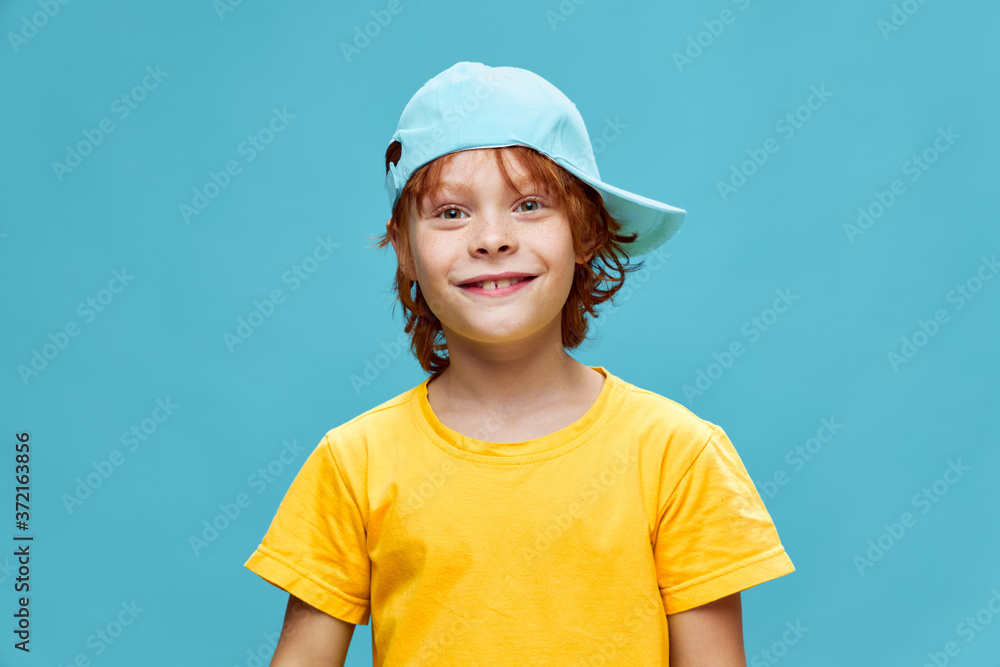 Red-haired child with a freckle cap on his face