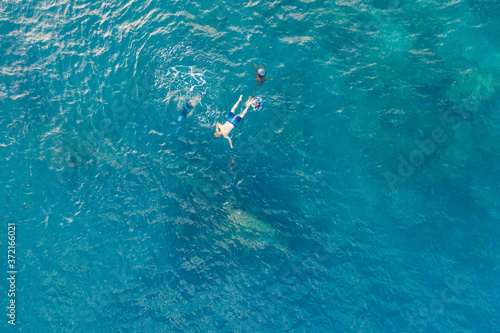 Three people snorkling in the ocean in Amed  Bali  Indonesia