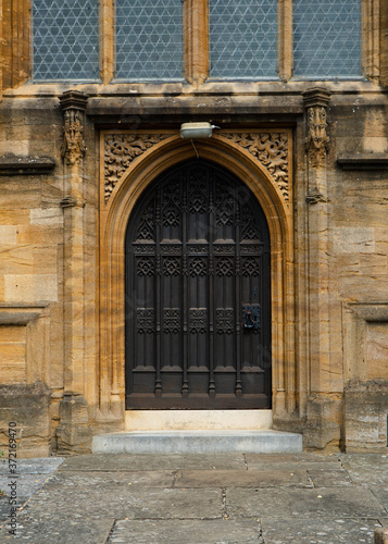 Heavy wood arched door way set into the abbey in Sherborne  United Kingdom.  