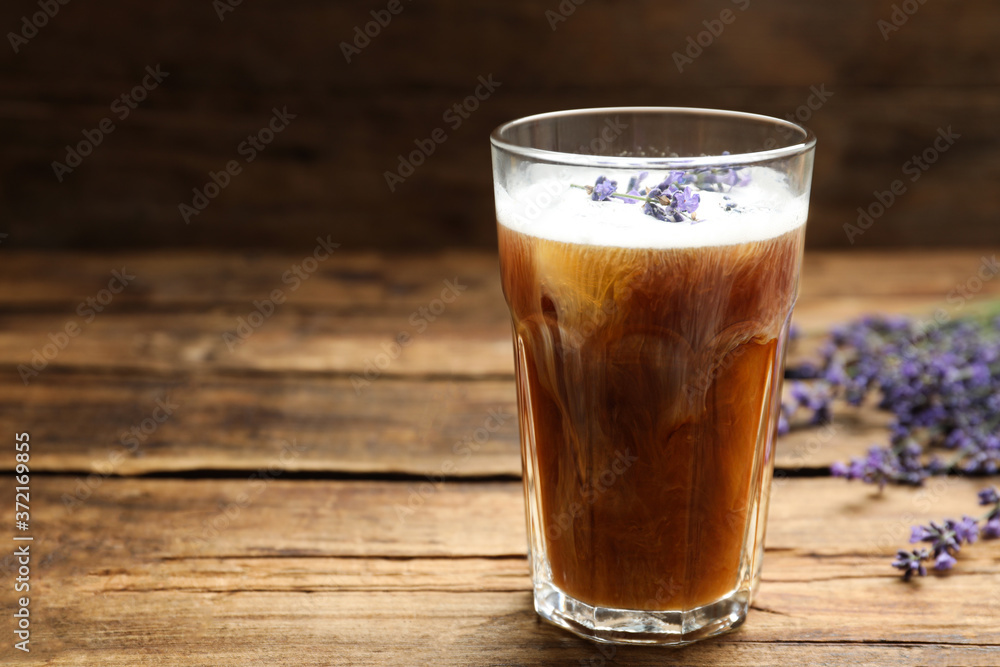 Delicious coffee with lavender on wooden table. Space for text