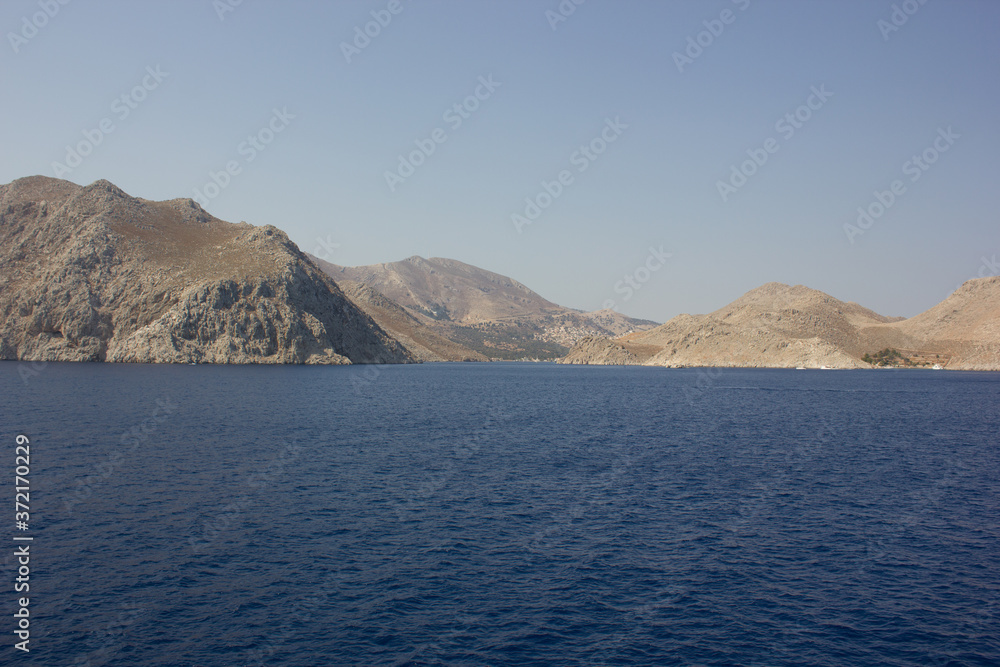 Greece. Rhodes island. Rest at the sea. Euro-trip. Sea water surface. Mountains in the background.