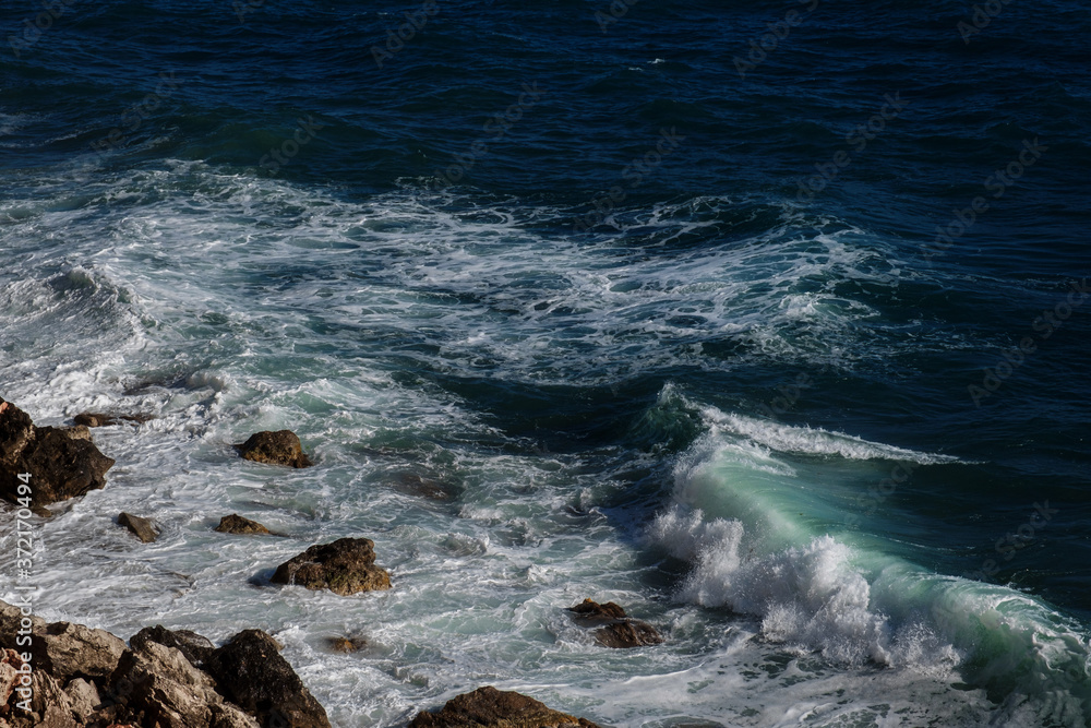 Ocean wave background breaking sea water rocky shore