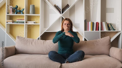A young woman frowns at the bad smell in the room. Spoiled air