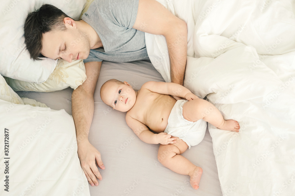 Father sleep near cute baby. Father sleep near cute baby.