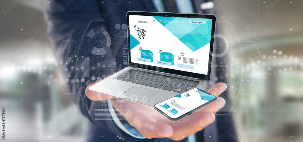 Businessman holding a Laptop and a smartphone - 3d rendering Businessman holding a Laptop and a smartphone - 3d rendering