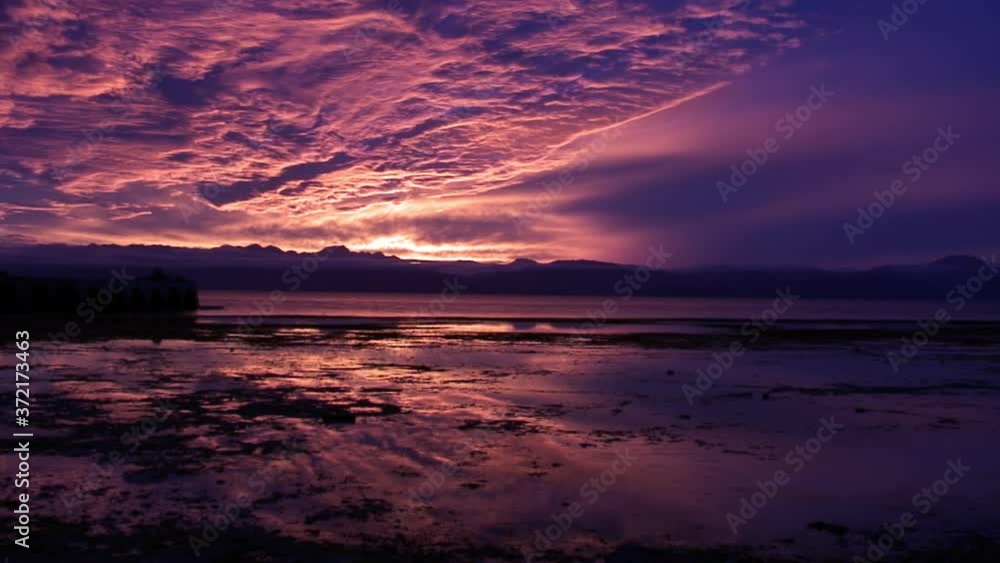 Scarlet purple sunset over sea on background of heavy clouds and a amazing coastline and skyline on islands of Republic of Philippines. Scarlet purple sunset over sea on background of heavy clouds and a amazing coastline and skyline on islands of Republic of Philippines.