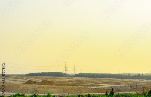 Electricity pole with silhouette sunset sky, Electricity pylon with shadow of tree in dawn time, Electricity power transmission line on sunset with copy space, Electricity pylon on orange sky