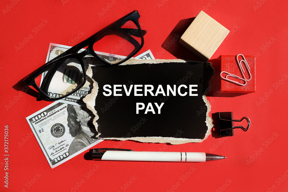 severance pay. THE WORD IS WRITTEN ON BLACK PAPER. On a red background