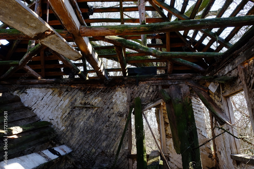 The ruins of an old abandoned house. Inside view. A dilapidated rural house.