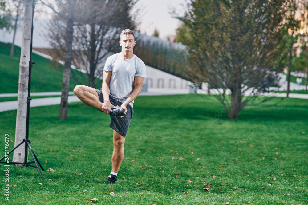 Sports man outdoors jogging physical activity exercise on the lawn Sports man outdoors jogging physical activity exercise on the lawn