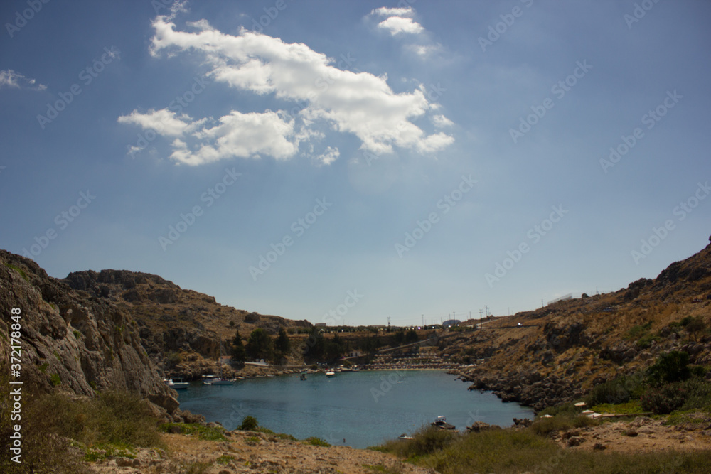 Greece. Rhodes island. Rest at the sea. Euro-trip. Sea water surface. Mountains in the background.