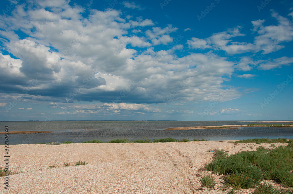 Steppe lake, landscape with clouds