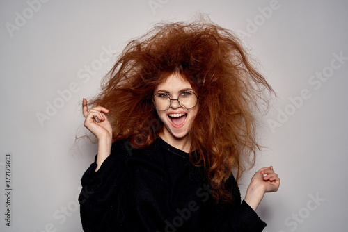 Obraz na plátne Brunette in a devil costume on Halloween red horns glasses black dress