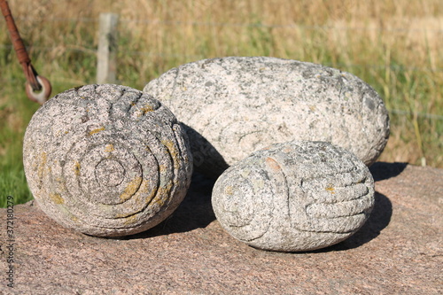 Historic triskele carved oblong stones, Neolithic carved stone ball similar design to Towie balls, Tarland, Aberdeenshire, Scotland, 15/08/2020: