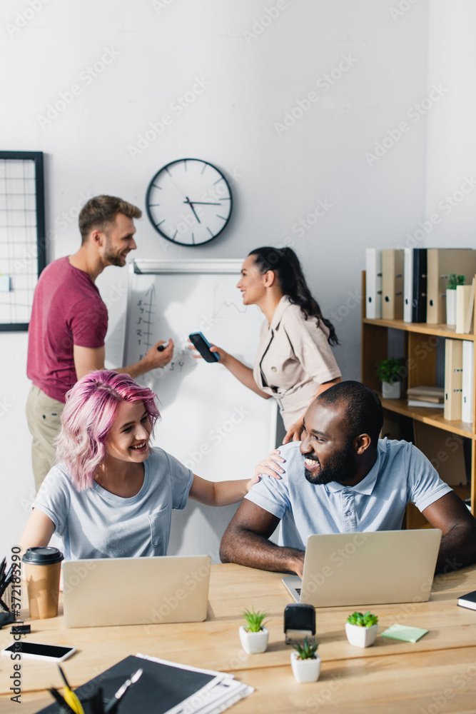 Fototapeta premium Selective focus of business people working with gadgets in office