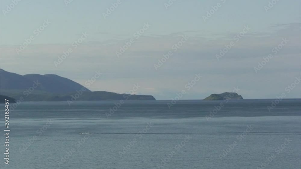 Mountain landscape with green trees on background of Rocky coastline of lake Baikal and atmosphere of peace for exotic ecotourism in wildlife Siberia in Russia. Mountain landscape with green trees on background of Rocky coastline of lake Baikal and atmosphere of peace for exotic ecotourism in wildlife Siberia in Russia.